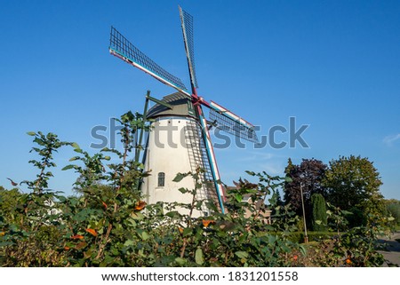 Old Dutch white windmill with blue sky background in Holland