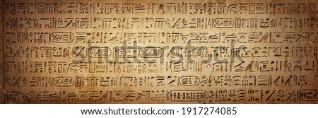 Old Egyptian hieroglyphs on an ancient background. Wide historical background. Ancient Egyptian hieroglyphs as a symbol of the history of the Earth. 