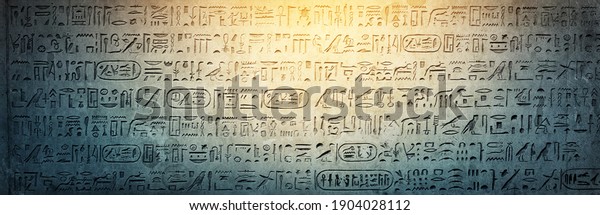Old Egyptian hieroglyphs on an ancient\
background. Wide historical background. Ancient Egyptian\
hieroglyphs as a symbol of the history of the Earth.\
