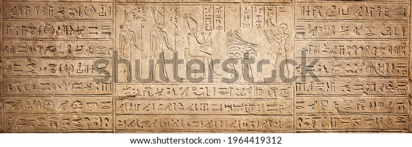 Old Egyptian hieroglyphs on an ancient
background. Wide historical background. Ancient Egyptian
hieroglyphs as a symbol of the history of the Earth.
