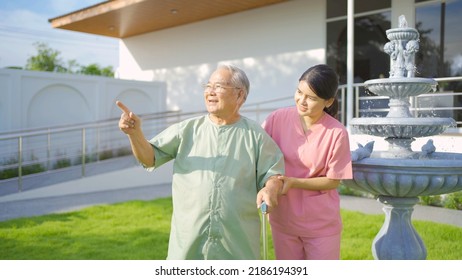 Old Elderly Asian Patient Or Pensioner People Walking By Walker With A Nurse, Relaxing, In Nursing Home In Garden Park. Senior Lifestyle Activity Recreation. Retirement. Health Care Physical Therapy.