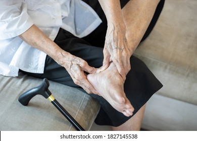 Old elderly with foot injuries,heel pain or ankle diseases,asian senior woman suffer from plantar fasciitis,tendon connecting calf muscles to the heel injury,achilles tendinitis after walk exercising