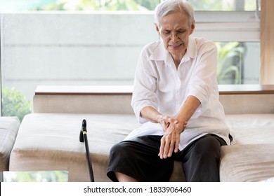 Old Elderly Patient Suffer From Gout,rheumatoid,chronic Arthritis With Severe Pain,injury Wrist Bones,Asian Senior Woman Is Rubbing And Massaging Her Wrist,beriberi In Hands Or Numbness Of The Fingers