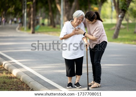 Old elderly with short of breath and chest pain from heart disease, heart attack or heart failure while walking to exercise in outdoor at the park,senior woman with illness,symptoms of dyspnea,angina
