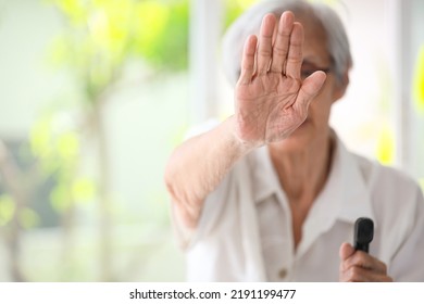 Old elderly woman making stop gesture with palm,campaign against family domestic violence,asian senior people raise hand to show sign,stop violence against women,physical abuse,human rights violation