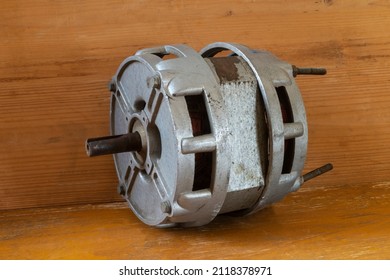 An Old Electric Motor On A Wooden Table. Industrial Object Close-up.