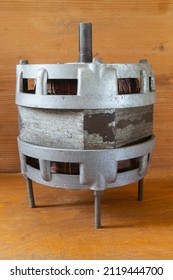 An Old Electric Motor On A Wooden Table. Industrial Object Close-up.