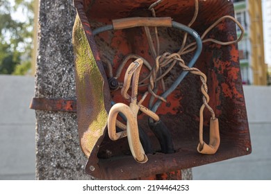 Old An Electric Power Supply Box With Broken Wires On A Streetlight Pole.