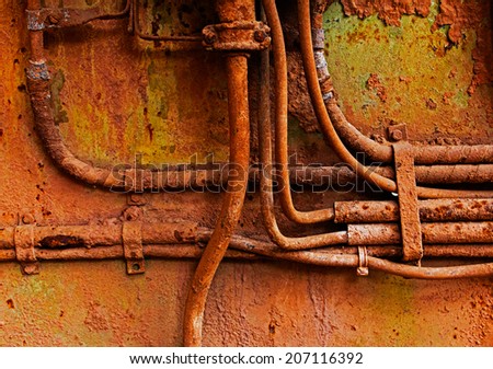Old electrical cables on a rusty iron wall
