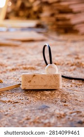 Old Electrical Power Strip and Cable on Wood Shavings in a Traditional Furniture Workshop