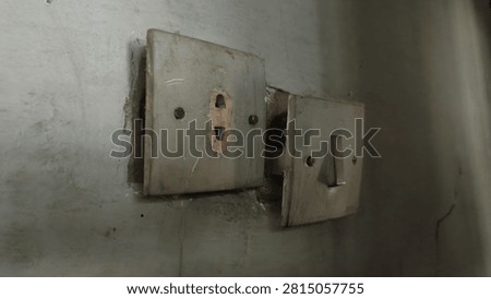 Old Electrical Switch and Power Outlet on Worn Interior Wall, Aging Home Infrastructure Concept