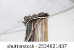 Old Electrical Wires and Damaged Wall in Need of Repair