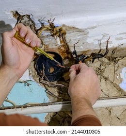 Old Electrical Wiring In The House, Wooden Walls In The House, Replacement Of Electrical Cables, The Master Checks The Old Wire For Contact With Electricity.