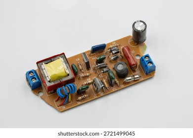Old electronic component microcircuit chip closeup on white.