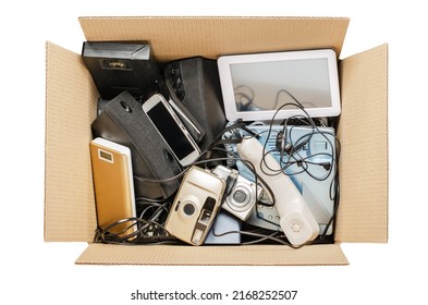 Old Electronic Devices In A Cardboard Box. The Concept Of Recycling And Disposal Of Electronic Waste. Isolated On White