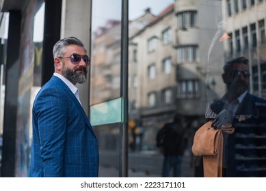 A Old Elegant Business Man Choosing A Suit In Mall Or Clothing Store While Looking At The Shop Window.