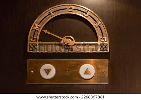 Old elevator floor indicator made of brass