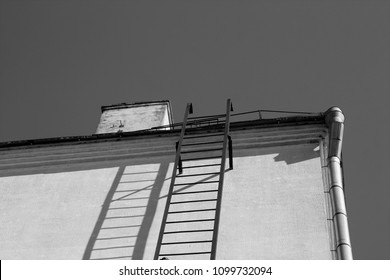 Old Emergency Fire Escape In Black And White. Urban Background And Texture.