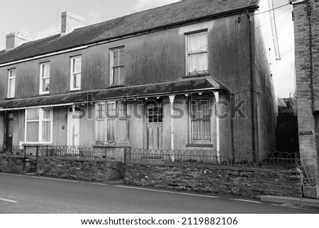 An old end of terrace house requiring some restoration in the town centre at St Clears, Carmarthenshire, Wales, UK.