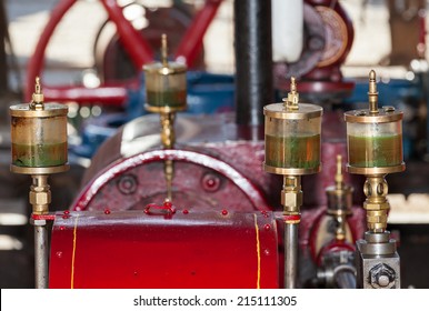 old engine brightly painted in red - Shutterstock ID 215111305