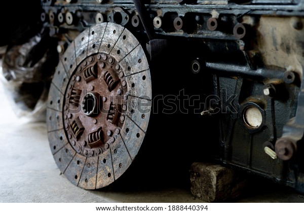 Old engine clutch disc of truck engine on the
garage floor