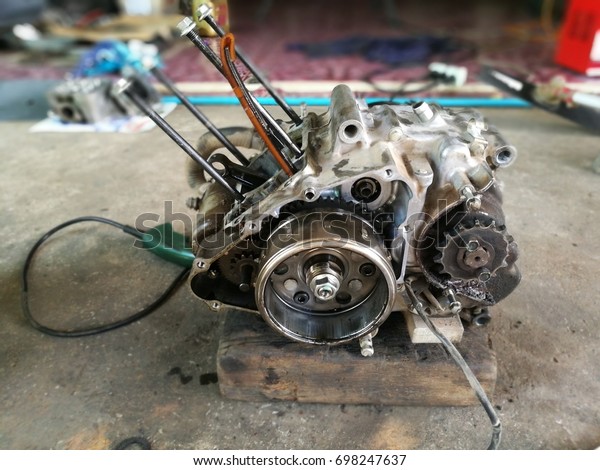 An\
Old Engine of Motorcycle wait for repair.Motorcycle engine is an\
engine that powers a motorcycle. Motorcycle engines are typically\
two-stroke or four-stroke internal combustion\
engines.