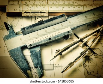 Old engineering tools on a technical drawing