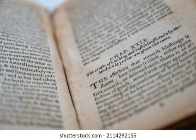An Old English Book Is Opened To A Section Of The Novel Revealing Slightly Discolored Pages And Ancient English Writing.