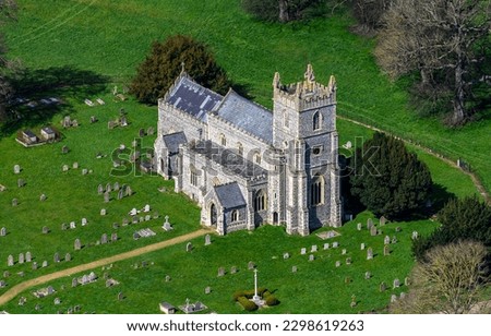 An old English church with a cemetery. Church cemetery. Medieval church with cemetery. Church in UK