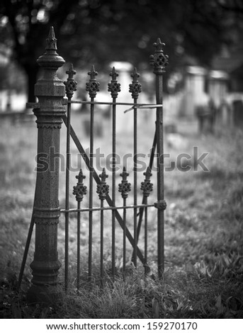 Old entrance gate and graves in an ancient church graveyard