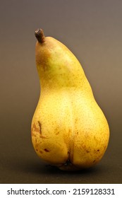 Old erotic pear on black background