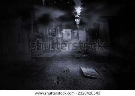 Old european abandoned cemetery  seeing a violated grave and skulls in the foreground on a full moon misty night 