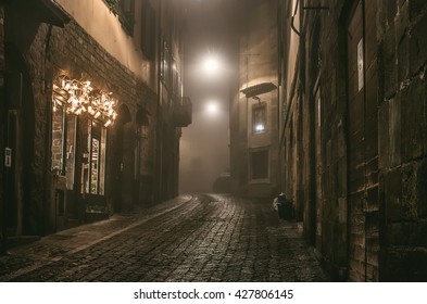 Old European narrow empty street of a medieval town on a foggy evening. Taken in Bergamo, Citta Alta