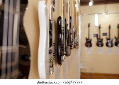 Old Excellent Electro And Bass Guitars On The Shelf In The Guitar Shop