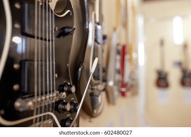 Old Excellent Electro And Bass Guitars On The Shelf In The Guitar Shop