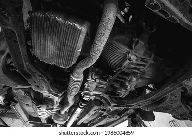 Old Exhaust Pipe, Flexible Corrugation Requires Replacement, Repair And Maintenance. Car Service, Vehicle Underbody Differential, In Oil. Black And White