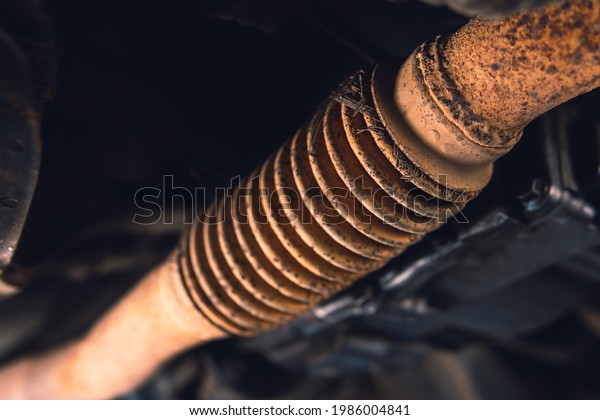 old exhaust\
pipe, flexible corrugation requires replacement, repair and\
maintenance. Car service, vehicle\
underbody