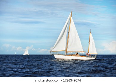 Old expensive vintage wooden sailboat (yawl) close-up, sailing in an open sea. Stunning cloudscape. Coast of Maine, US - Powered by Shutterstock