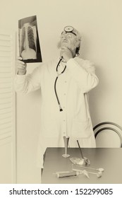 Old Faded Effect On A Vintage Doctor Examining An X-ray