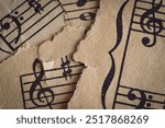 Old faded moody torn sheet music background with treble clef and bass clef