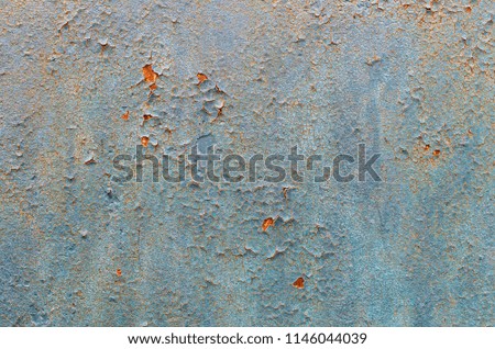 old faded paint with cracks on the surface of a metal plate, background texture retro style