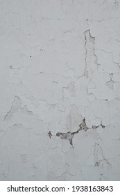 Old faded white paint with cracks and peeling, vintage background close-up, rough textured surface, weathering effect,