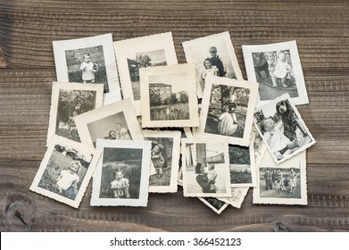 Old Family Photos On Wooden Table. Vintage Pictures 