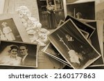 old family photos, pictures from 1935 in sepia color on wooden table, home archive documents, concept of family tree, genealogy, memories, memory of ancestors, family tree, nostalgia