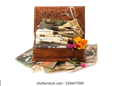 Old Family Photos Stacked In Wooden Box Isolated On White Background.