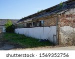 old farm building all forgotten and falling down.