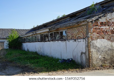 old farm building all forgotten and falling down.
