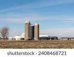 Old farm buildings, including grain silos and barns, in rural Livingston county.  Illinois, USA.