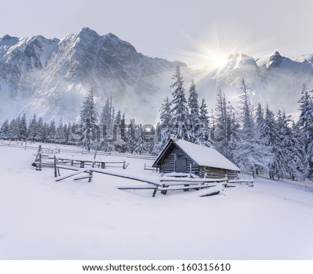 Old farm in the mountains. Foggy winter morning.