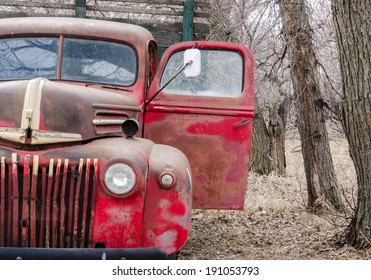 An Old  Farm Truck Abandoned In Some Trees